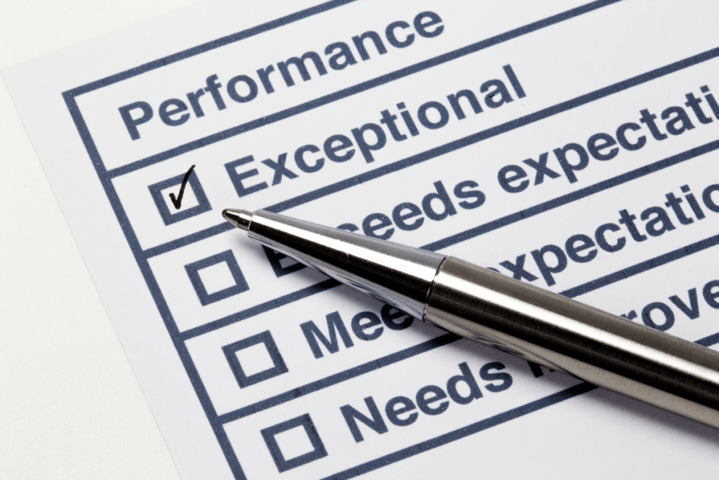 4 Powerful Ways Gamification is Revolutionizing Modern Marketing 11 Performance evaluation form with “Exceptional” checked and a pen resting on the paper, indicating assessment and tracking.
